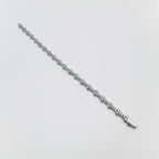 Silver bracelet with small diamonds on a light gray background